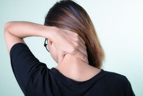 Woman massaging her neck for tension relief
