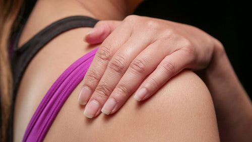 Hand resting on shoulder after a massage for muscle relief