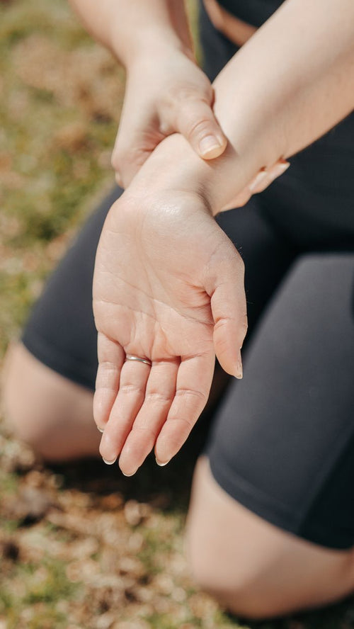 Woman holding her wrist for pain relief